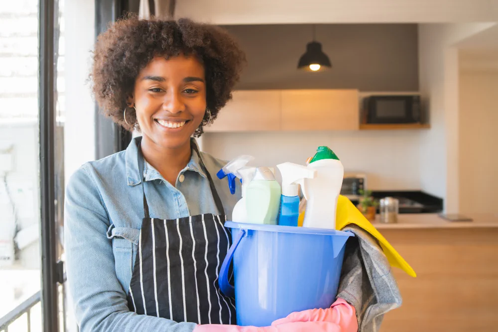 Cleaning professional holding supplies ready for a cleaning visit