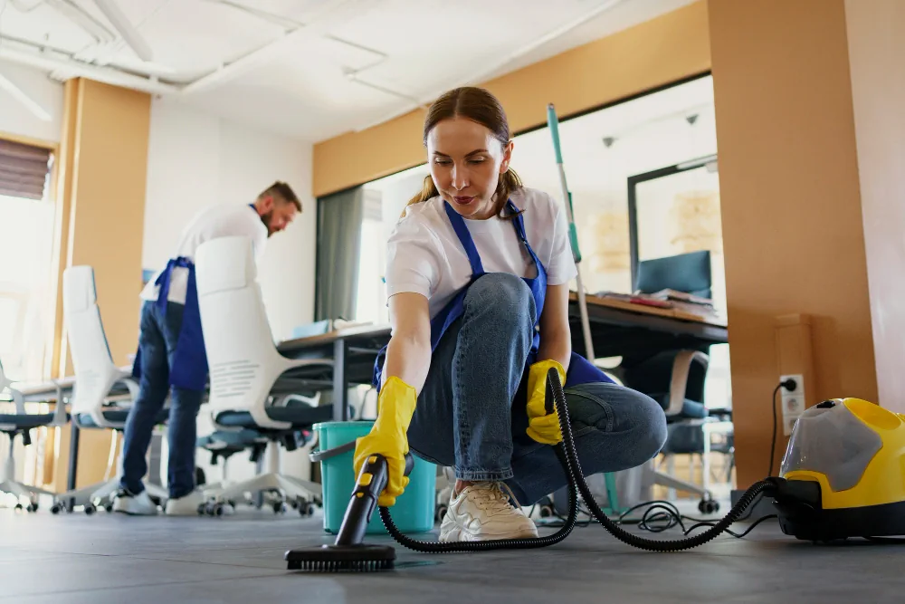 Cleaning professional vacuuming a floor inside a home