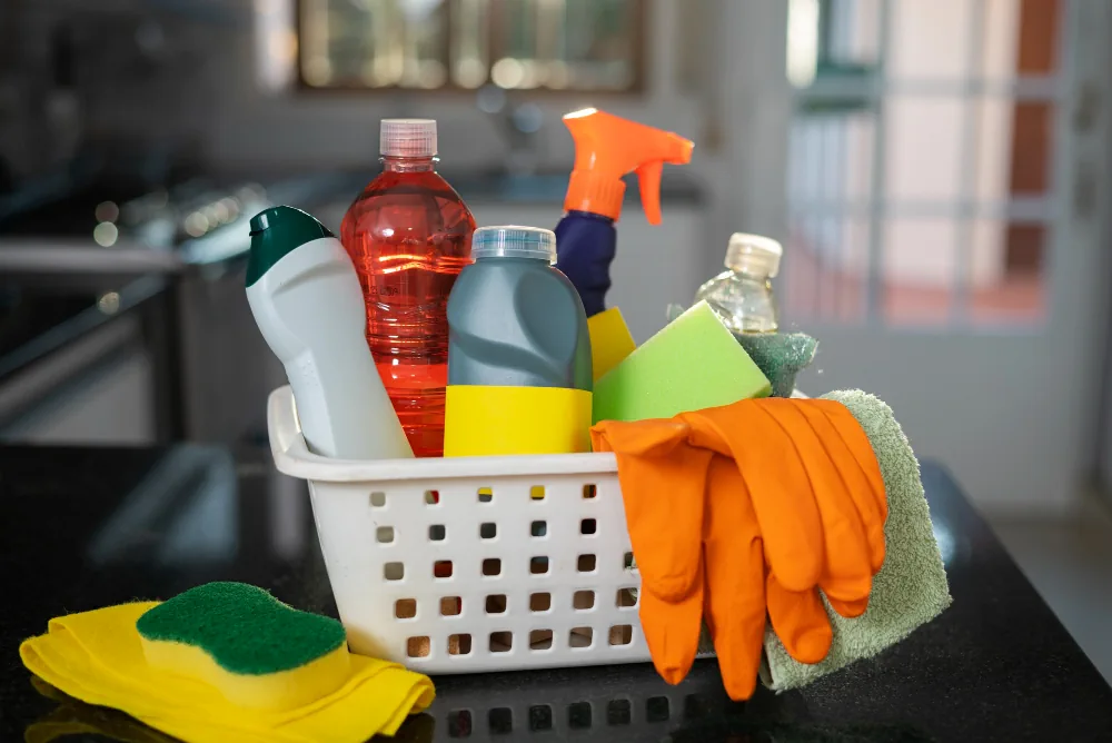 Basket of cleaning supplies with protective gloves