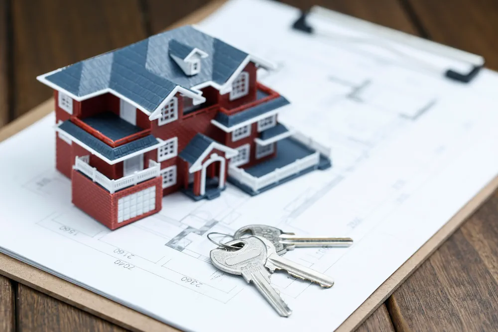 Property model and keys representing real estate planning